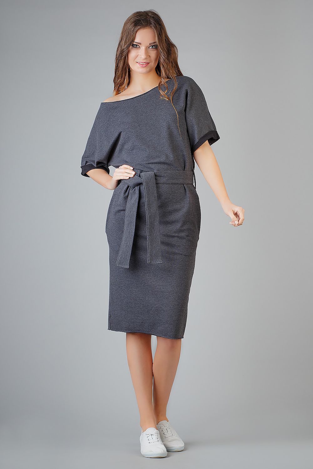 Elegant loose-fitting kimono dress by Tessita features decorative cuffs and side pockets, embodying luxury and comfort in fashion.