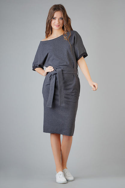 Elegant loose-fitting kimono dress by Tessita features decorative cuffs and side pockets, embodying luxury and comfort in fashion.