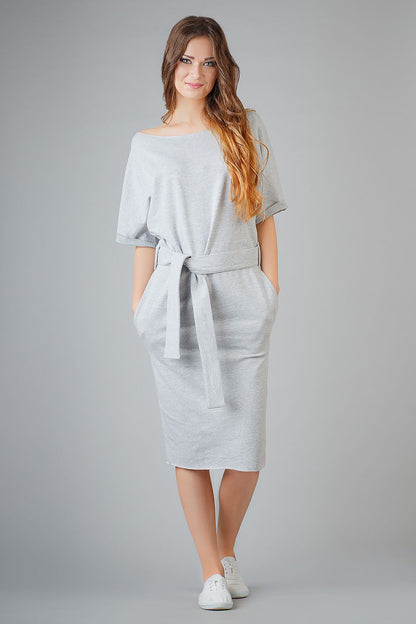 Elegant loose-fitting Kimono Dress by Tessita, with pockets and decorative cuffs, designed for comfort and sophistication.