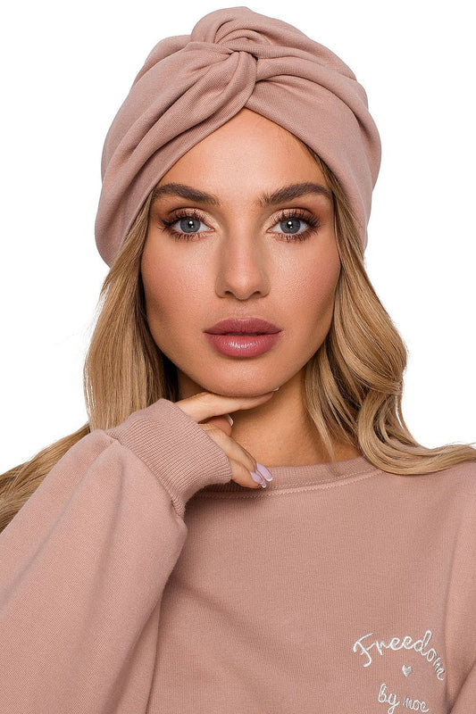 Elegant woman showcasing the Luxury Lightweight Knitted Cap with Turban Pattern in a soft pink hue by Moe, highlighting its stylish design and luxurious comfort.