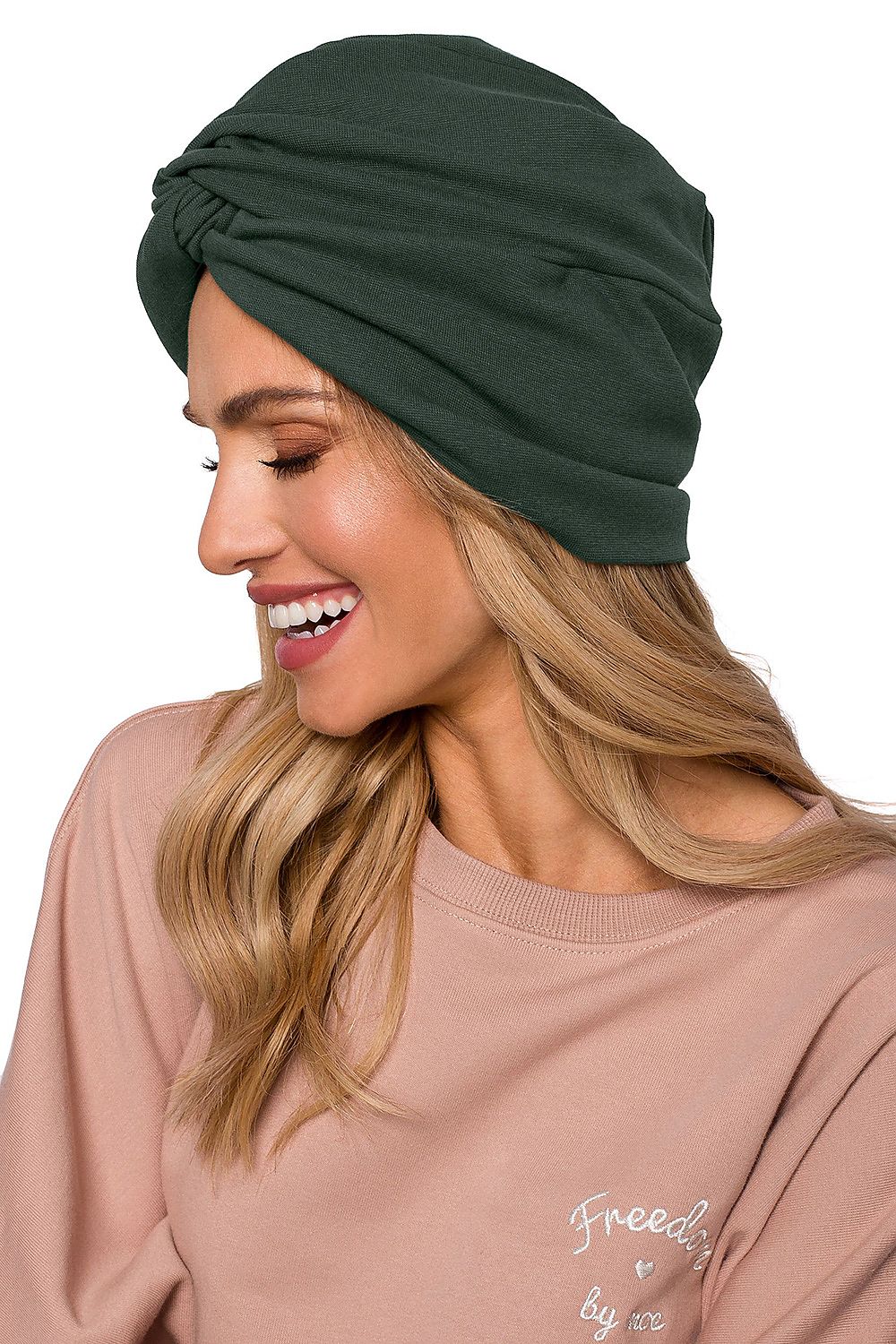 Side profile of a chic woman showcasing a luxury lightweight knitted cap with a turban design in green, crafted for comfort by Moe.
