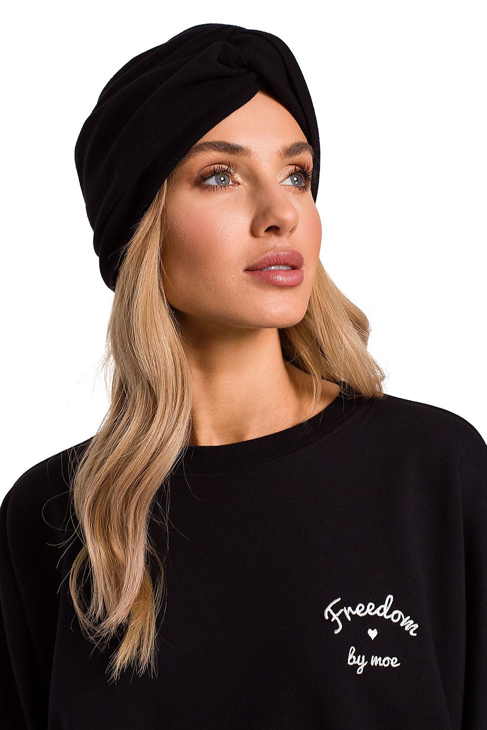 Fashionable woman wearing a luxury lightweight knitted cap in classic black with a turban design, perfect for everyday elegance by Moe.