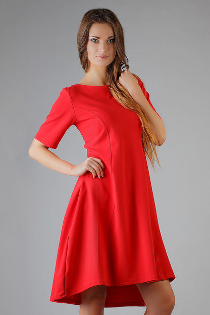 Elegant Tessita Flared Knit Dress with Boat Neckline and French Cut in luxurious fabric, showcasing its flared silhouette and feminine design.