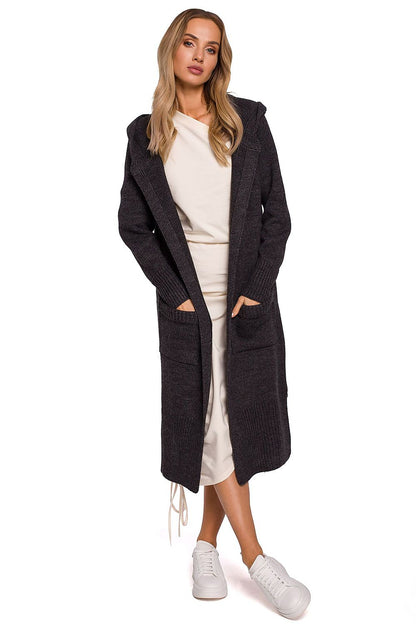 Luxurious long cardigan with fitted hood, pockets, and side slits by Moe, elegantly showcased on a model, wearing a sophisticated outfit with sneakers.