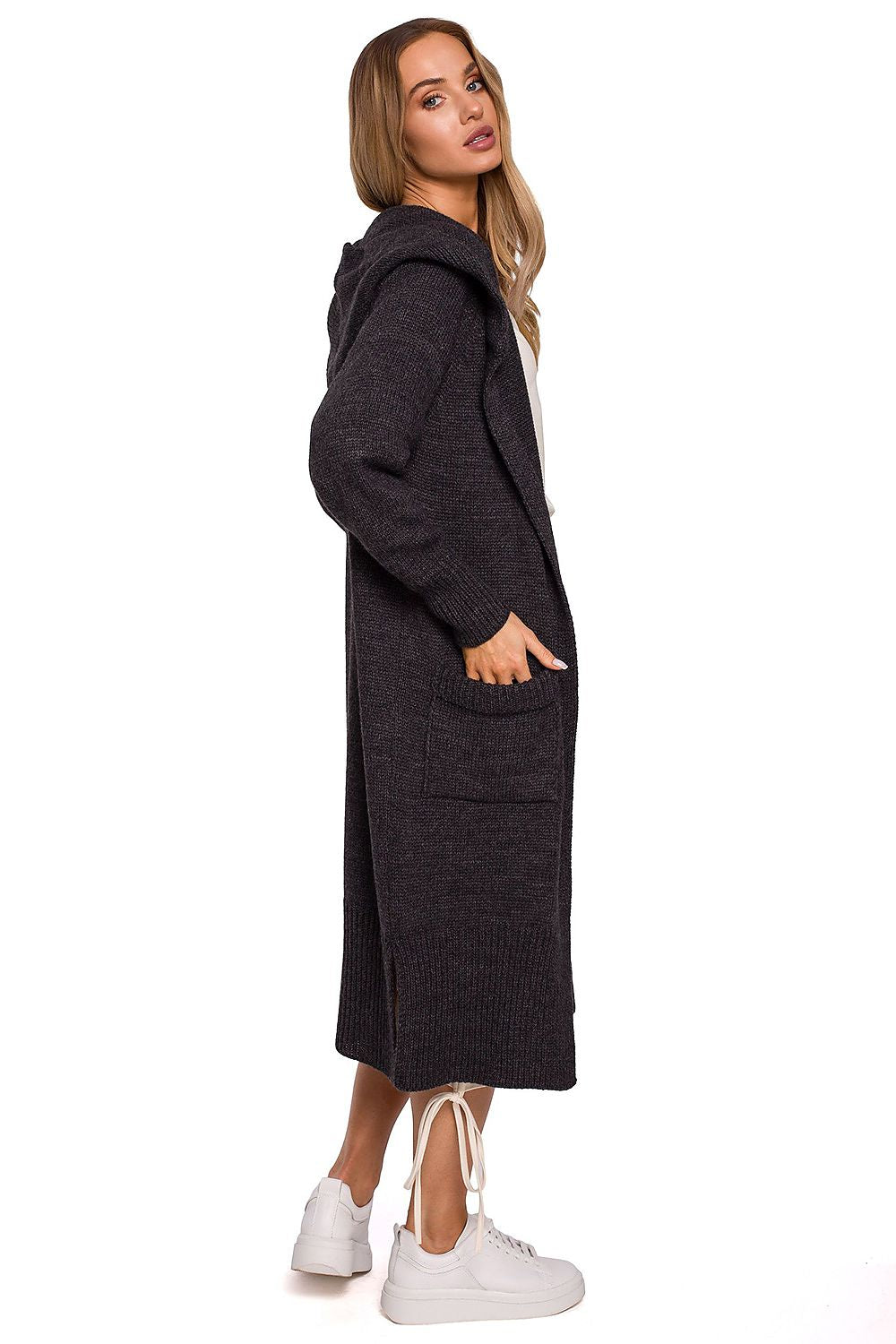 Side view of the luxurious long cardigan with fitted hood, pockets, and side slits by Moe, highlighting its stylish design and texture on a model.