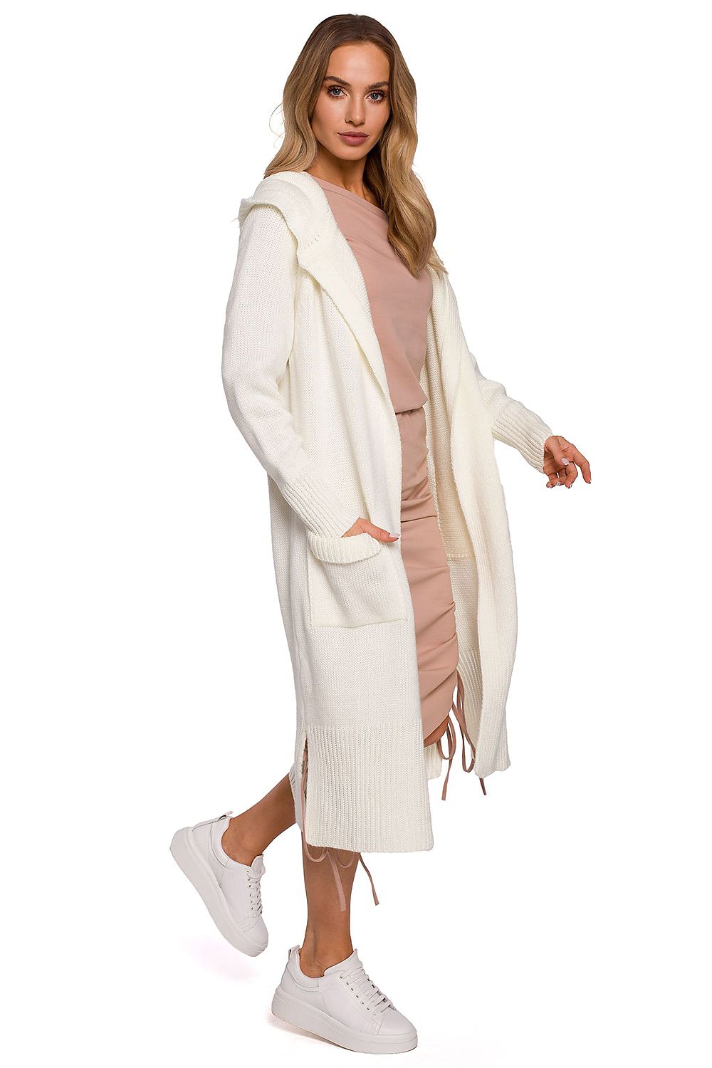 Chic white long cardigan with fitted hood, pockets, and side slits by Moe, elegantly styled on a model with casual attire and white sneakers.