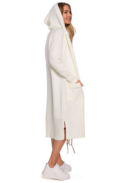 Profile view of the luxurious white long cardigan with fitted hood, pockets, and side slits by Moe, accentuating its fashionable silhouette worn by a model.
