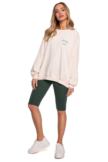 Sophisticated front view of a model wearing Moe Short Leggings for Sports, combined with a stylish oversized sweater, ideal for a chic athletic look.
