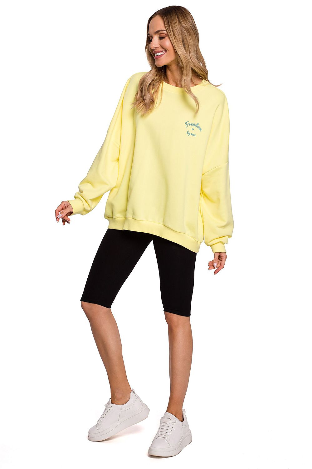 Elegant model showcasing Moe Short Leggings for Sports - Crafted from a soft cotton blend, featuring a comfortable elastic waist and logo detail, perfect for active pursuits.