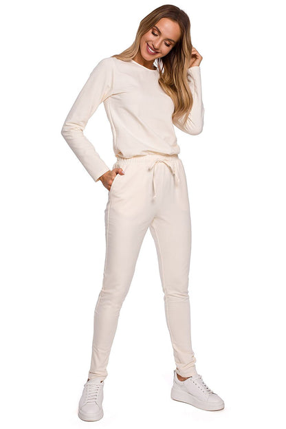 Elegant women's fitted one-piece jumpsuit with adjustable waistband and multiple pockets by Moe, presented in a soft cream colour, embodying luxury and sophistication for everyday wear.