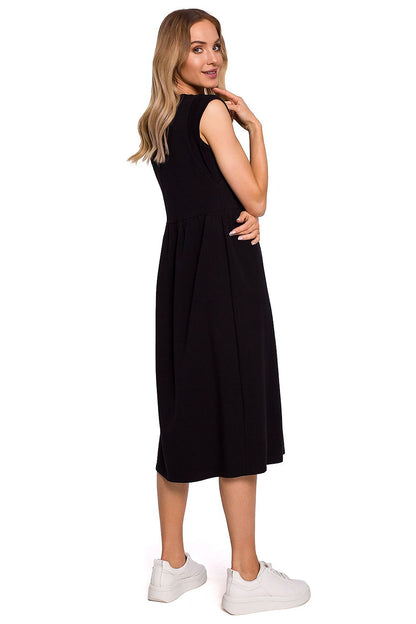 Stylish side view of Moe Midi Length Knitted Dress with High Waist Cut and Loose Skirt, seamlessly blending comfort with luxury for a fashionable look.