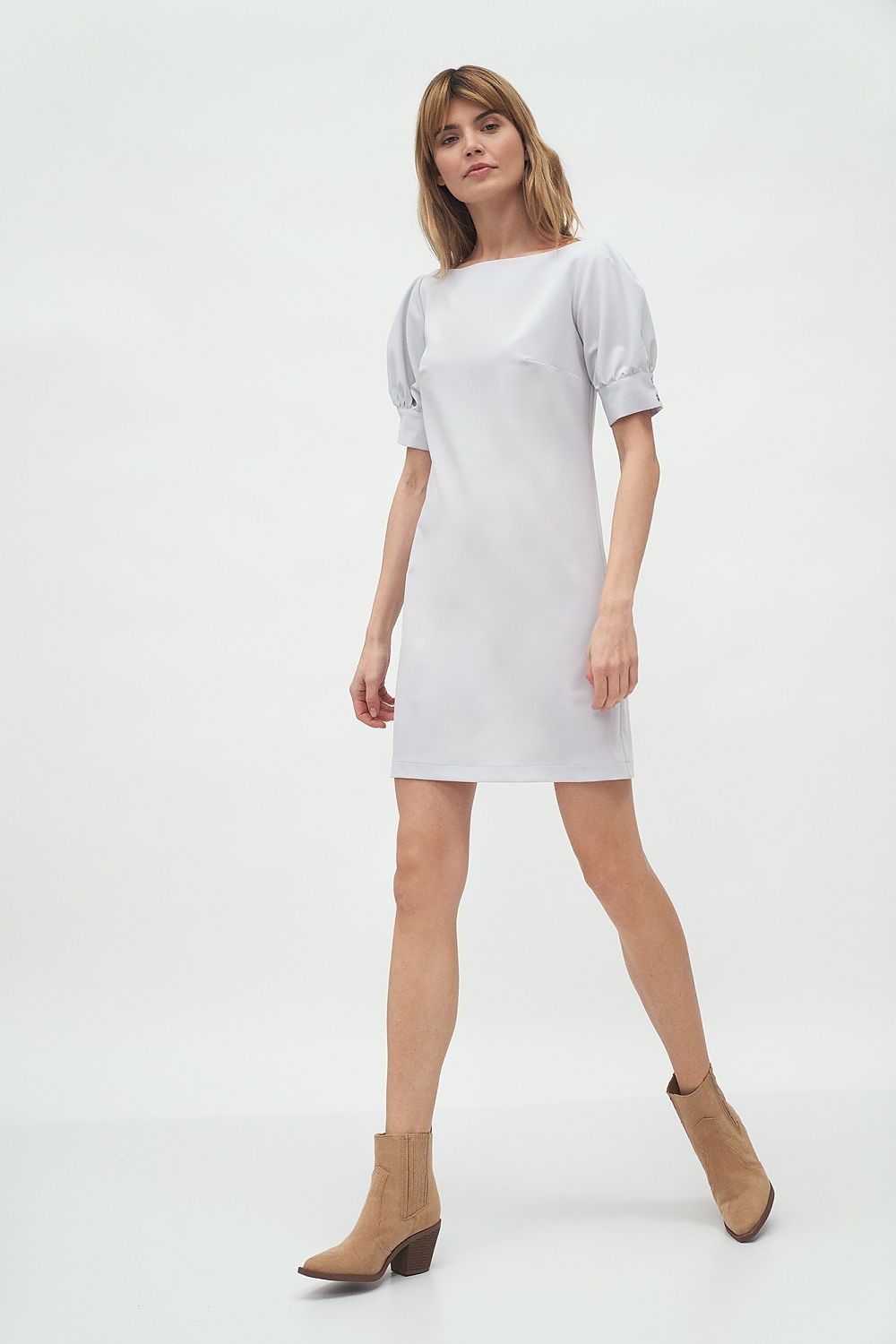 Fashionable walking pose of a model in the Elegant Boat Neck Daydress by Nife with Buffet Sleeves, ideal for work or business meetings.