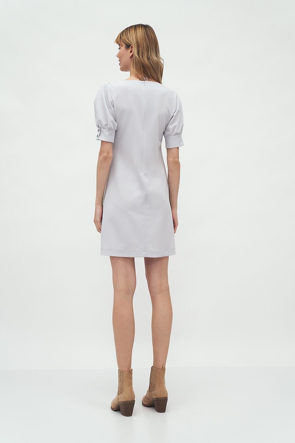 Rear view of the model in the Elegant Boat Neck Daydress by Nife with Buffet Sleeves, highlighting its sophisticated design and luxurious fabric.