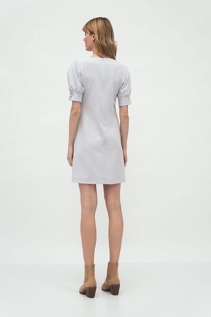 Rear view of the model in the Elegant Boat Neck Daydress by Nife with Buffet Sleeves, highlighting its sophisticated design and luxurious fabric.