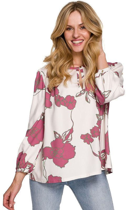 A smiling model showcases a Luxury Floral Viscose Blouse by Makover, featuring an elegant floral pattern and versatile cut perfect for both casual and elegant wear.