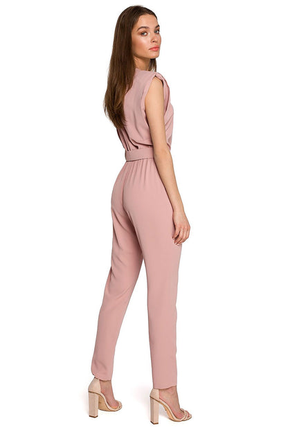 Stylish pink jumpsuit by Stylove, showcasing a loose fit, shoulder pads, and a belted waist at the back, ideal for fashionable outings.