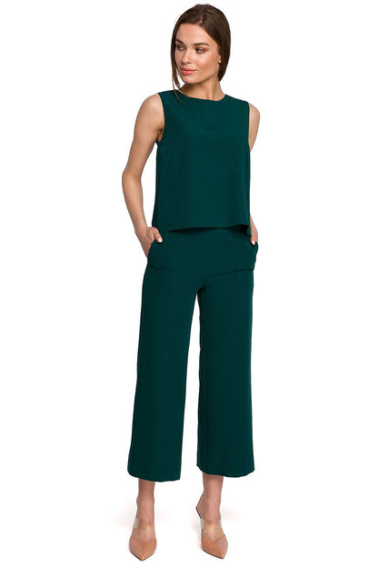 Stylove Blouse Stylove displayed as part of a sophisticated outfit, encompassing a sleek green sleeveless blouse that exudes luxury.