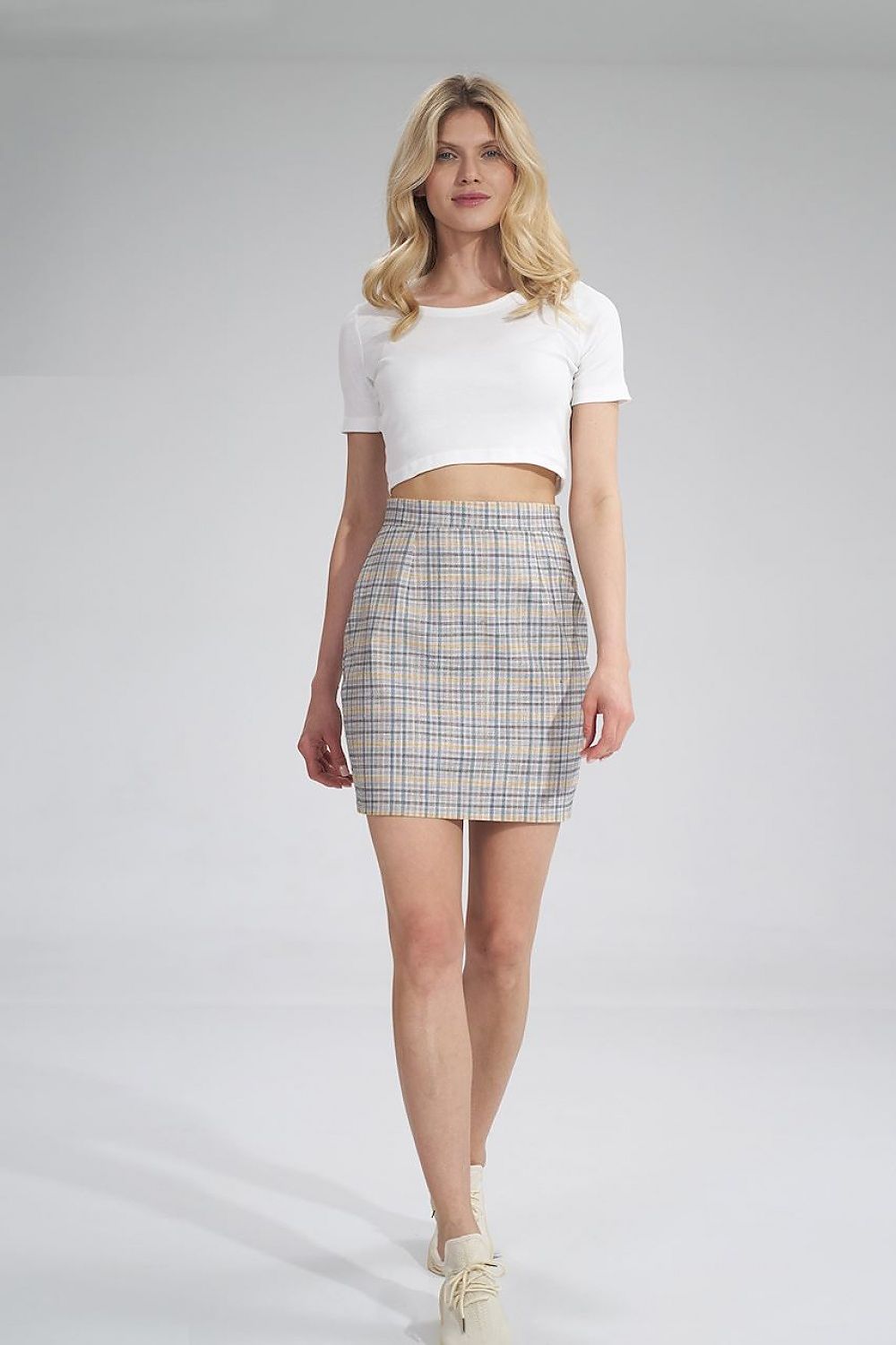 Sophisticated front view of the Short skirt by Figl, highlighting the tailored fit and fashionable plaid design worn with a cropped white tee.