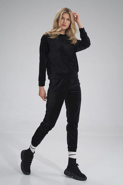 Chic black velour tracksuit trousers by Figl, offering a sophisticated look with a comfortable fit and modern flair.