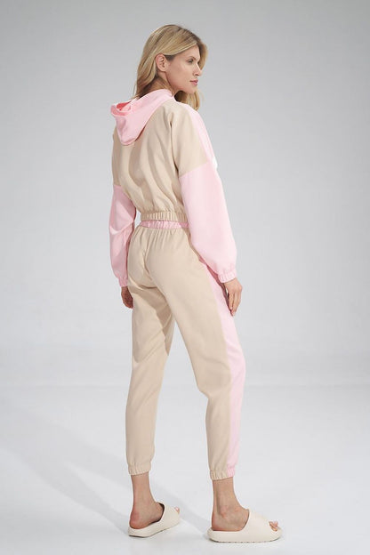 Chic Figl tracksuit trousers displayed from the back, highlighting the elegant piping detail and sporty silhouette, crafted for comfort and style.