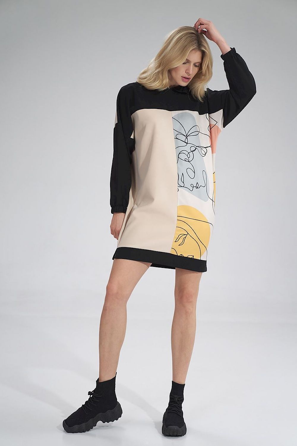 Stylish Daydress Figl displayed on a model, highlighting its unique three-coloured aesthetic with a fashionable hood and contemporary silhouette.