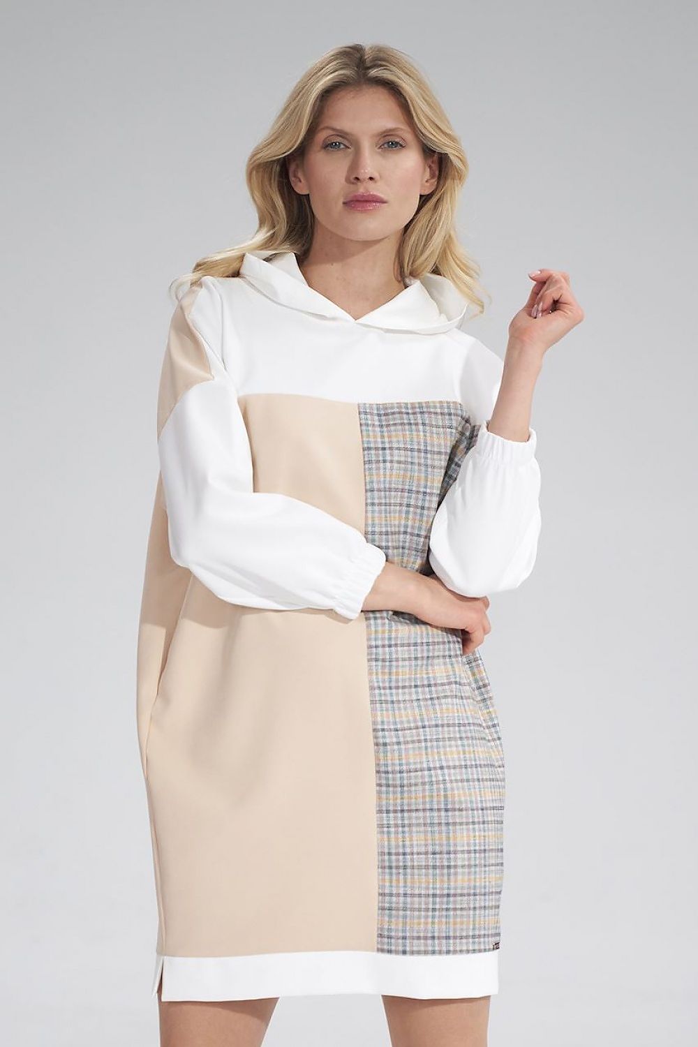 Chic Daydress Figl with a stylish hood and plaid detail, modeled elegantly to reflect modern luxury for the discerning woman.