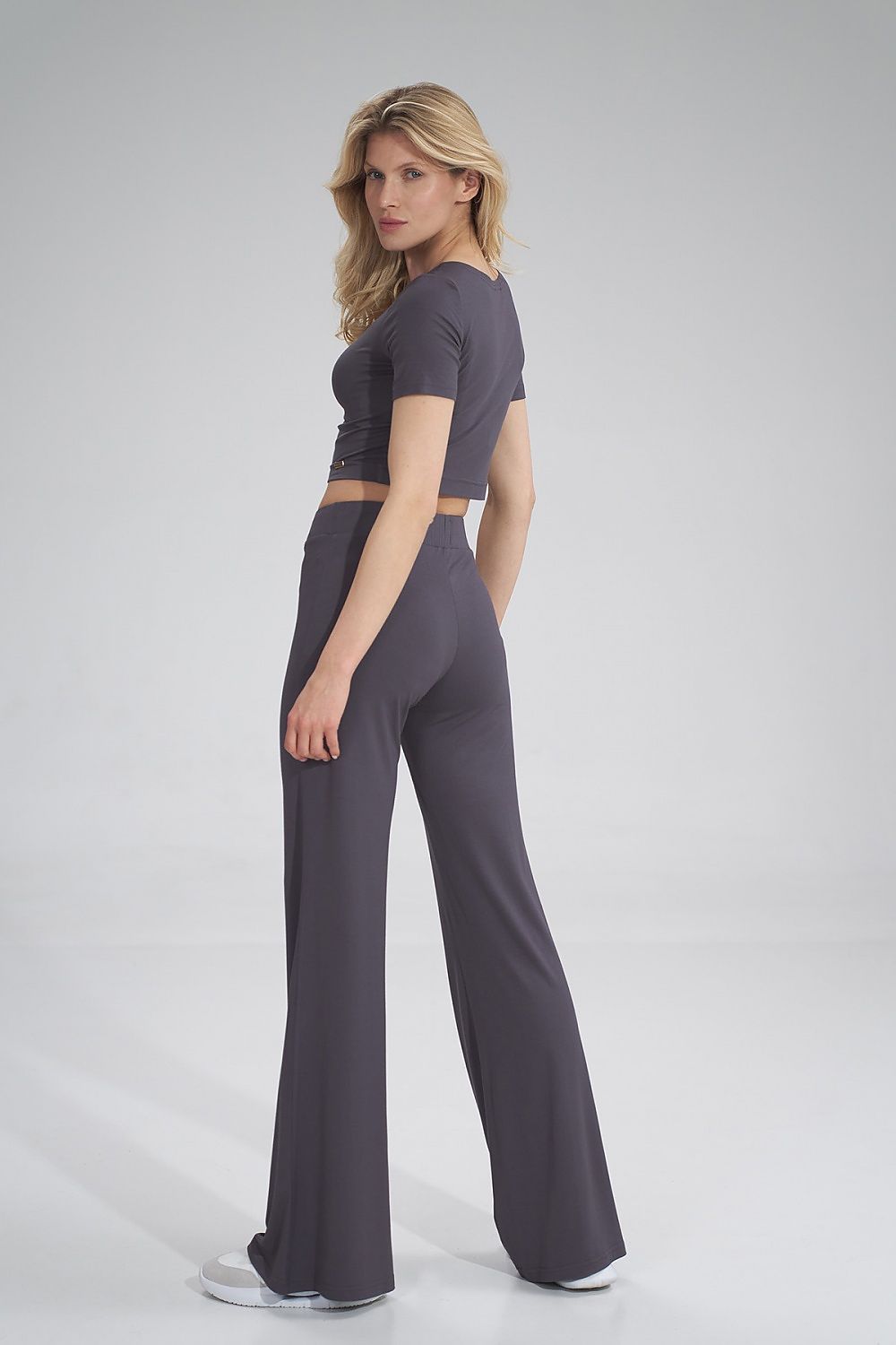 Sophisticated cropped blouse by Figl, styled elegantly with high-waisted trousers, showcasing a chic and modern silhouette.