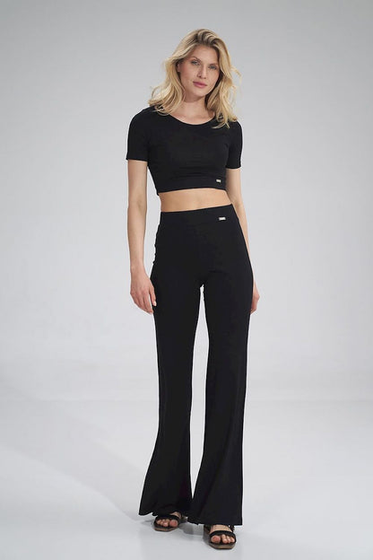 Sophisticated look featuring the Figl crop style blouse paired with stylish black flared trousers, highlighted on a poised female model.