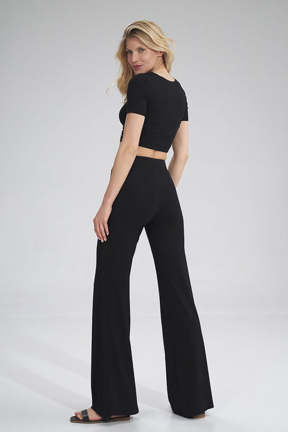 Chic rear view of a model wearing the Figl crop style blouse and flared black trousers, exuding elegance and modern sophistication.