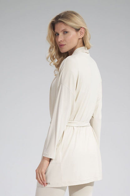 Elegant woman showcasing the Figl Sweatshirt in a soft beige hue, featuring a loose fit and belted design, perfect for a sophisticated look.