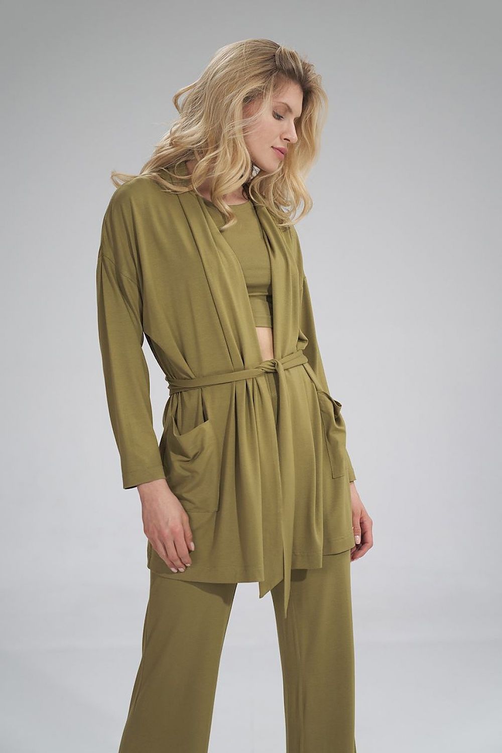 Chic model wearing the Figl Sweatshirt in a rich olive colour, demonstrating its luxurious fabric and relaxed silhouette.