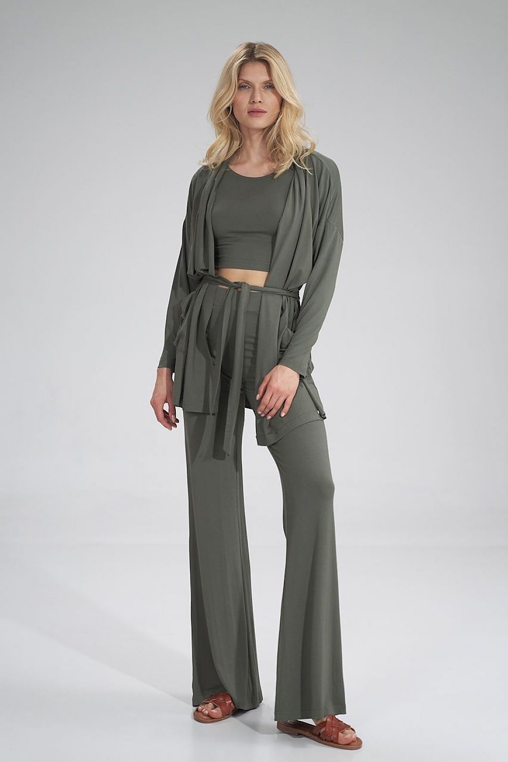 Graceful model showcasing the Figl Sweatshirt in deep forest green, accentuating its modern design with a stylish belt.