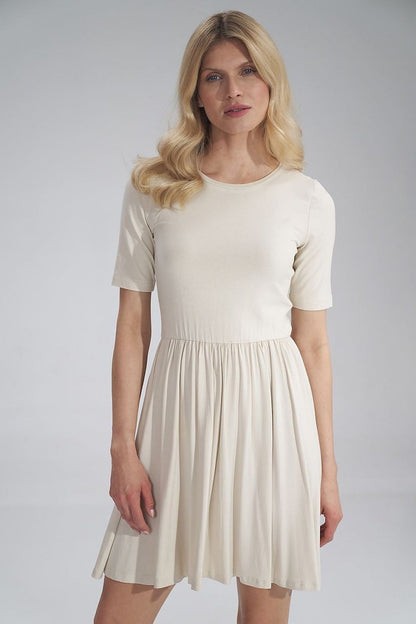 Elegant Daydress Figl in soft cream colour, featuring short sleeves and a gathered waist, perfect for summer outings.