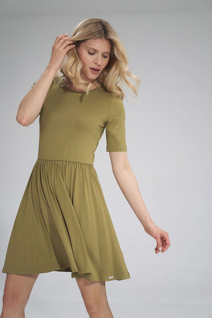 Elegantly styled summer sports dress by Figl, featuring short sleeves and a gathered waist design. The olive green dress has a half-round neckline and a slightly flared skirt, perfect for a chic summer outing.
