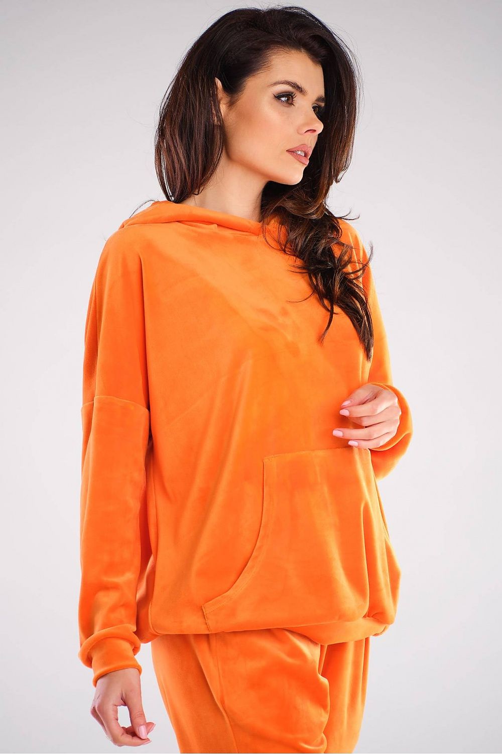 Close-up of the elegant orange velour sweatshirt by Awama, showcasing its comfortable fit and practical pocket, perfect for a contemporary lifestyle.