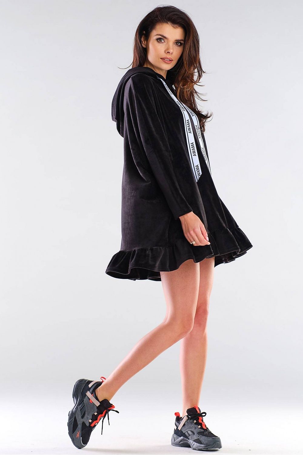 Side view of the luxurious Awama daydress, showcasing its versatile oversized design, a chic hood, and a playful frill, perfect for casual elegance.