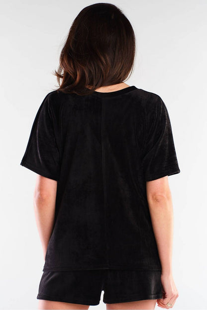 Back view of a luxurious black velour outfit by awama, combining plush shorts and a stylish top for an effortlessly elegant look.