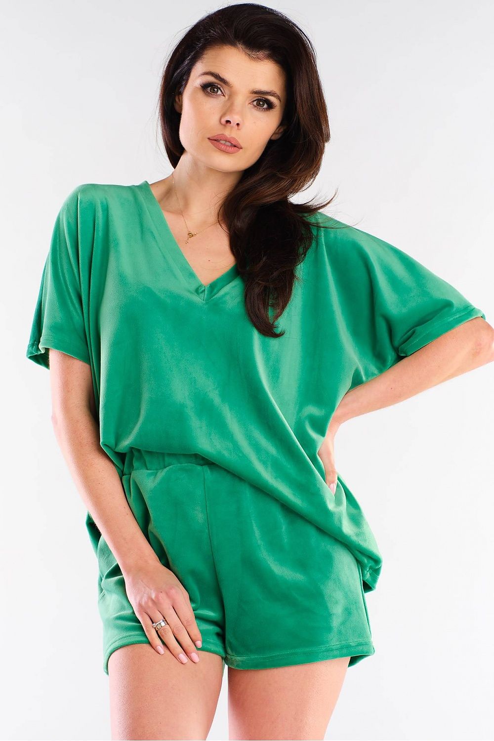 Stylish model showcasing Awama shorts in a vibrant green colour, designed for comfort and elegance with a relaxed fit, made from soft velour fabric.