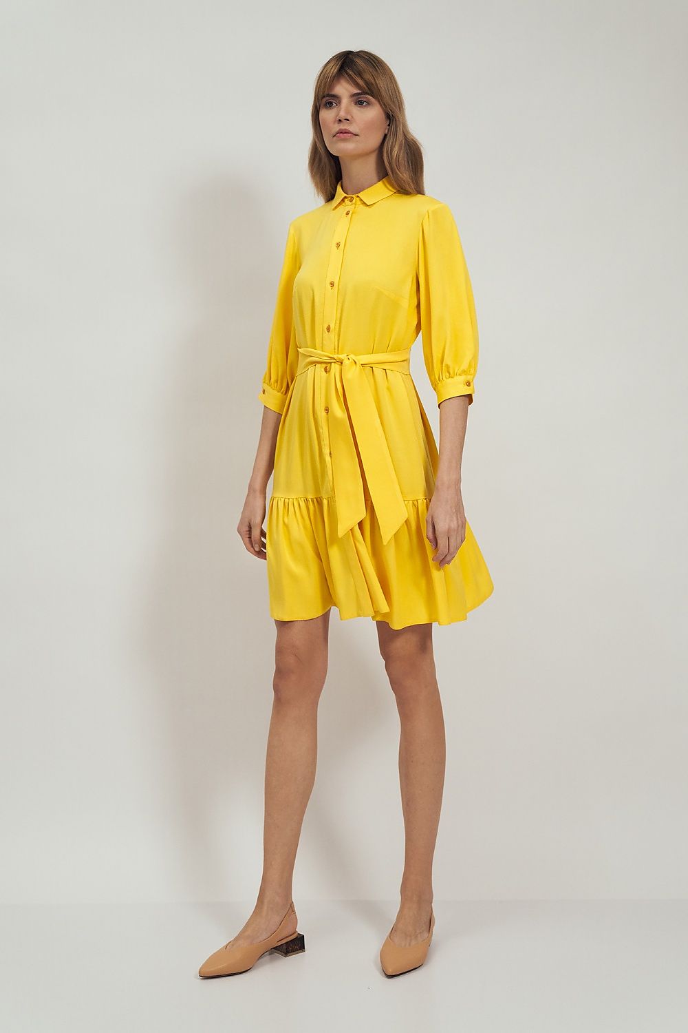 Nife Daydress Nife in elegant yellow, showcasing a tight-fitted waist and flared skirt, styled with puff sleeves and a chic collar, perfect for sophisticated occasions.
