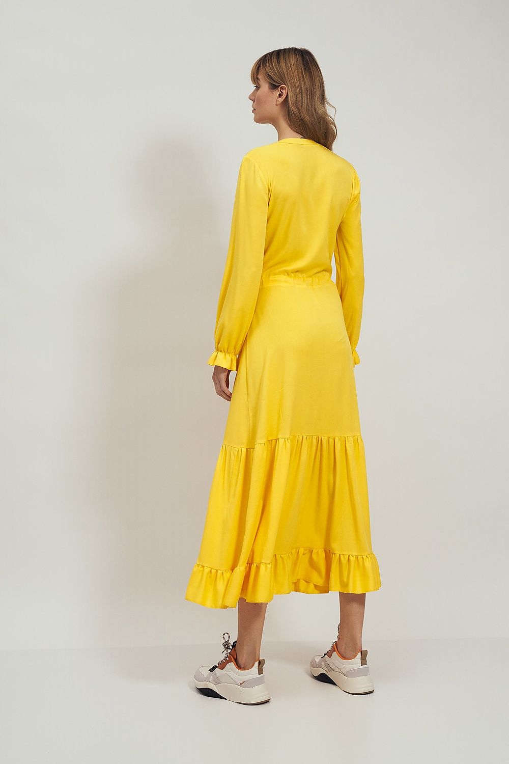 Sophisticated back view of the Daydress Nife, flowing yellow midi dress with a flattering fit and exquisite frill accents, an essential piece for a luxury wardrobe.