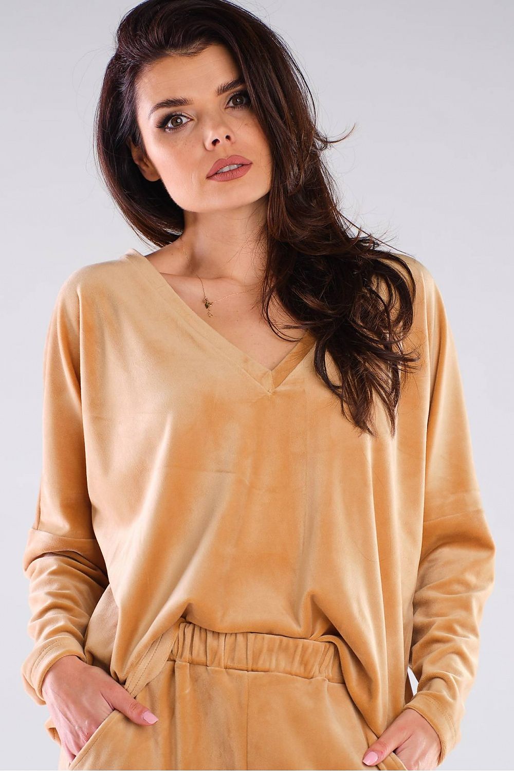Luxurious Awama women's loose-fit polyester sweatshirt in a warm beige shade, featuring a heart-shaped neckline, elegantly styled with straight sleeves and a relaxed silhouette.