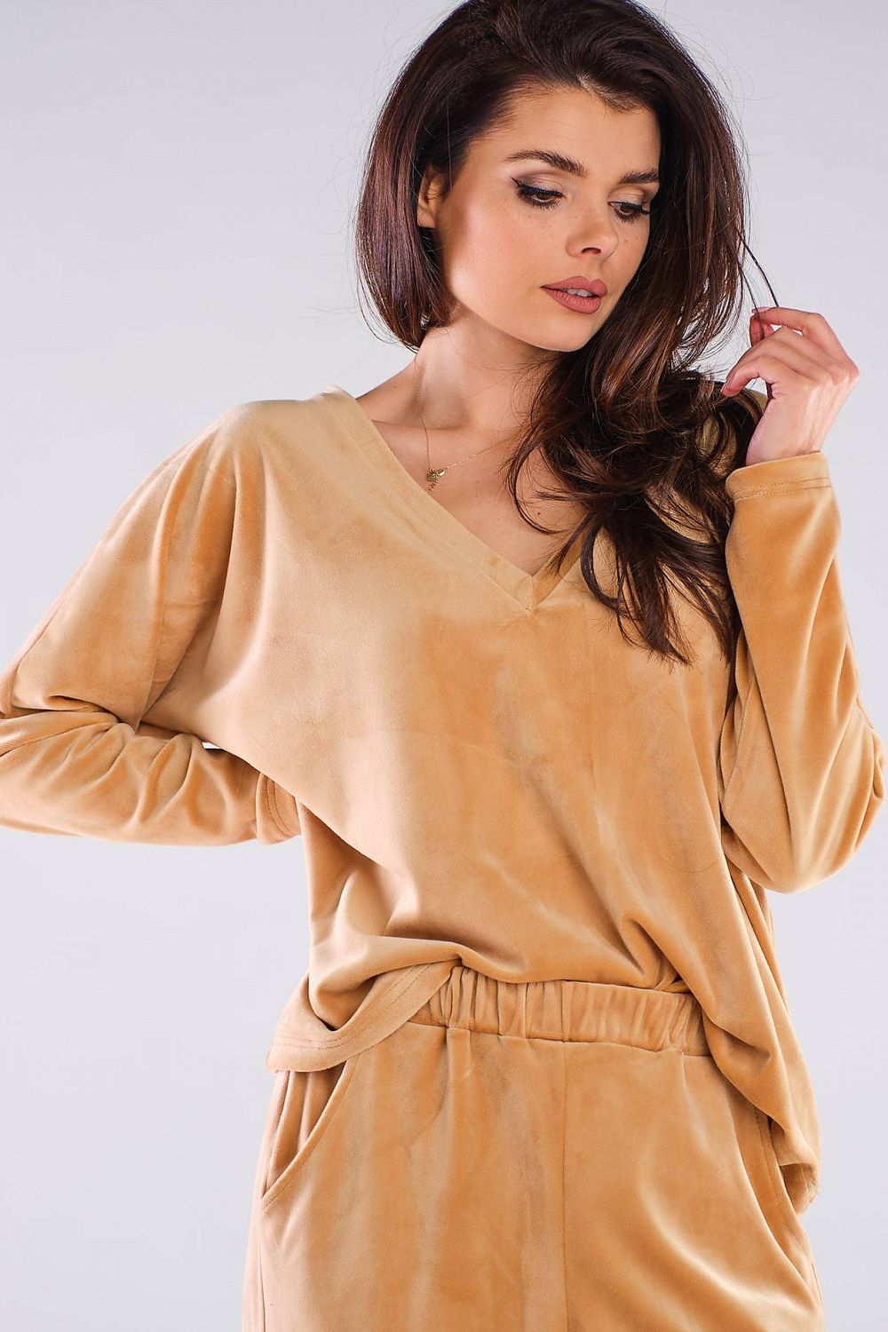 Close-up of an Awama women's luxurious polyester sweatshirt in beige, showcasing its heart-shaped neckline and feminine silhouette, suitable for refined casual wear.