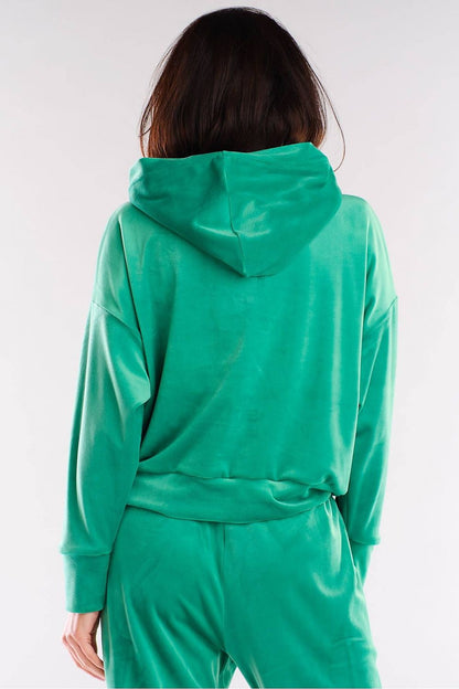 Back view of a model wearing a luxury green velour hooded kangaroo sweatshirt by Awama, emphasizing the soft fabric and trendy style.