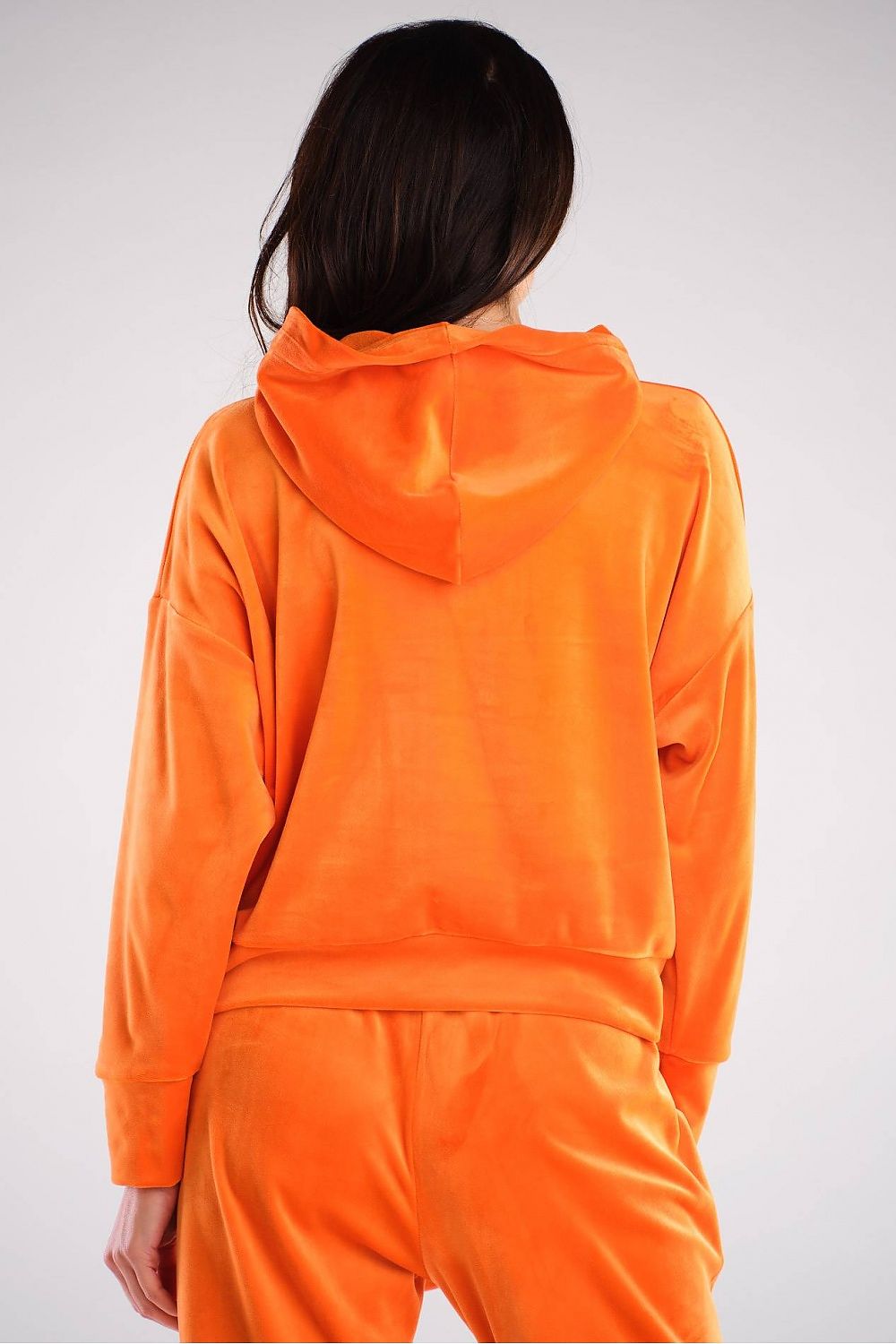 Elegant back view of a luxury velour hooded kangaroo sweatshirt by Awama, showcasing its soft fabric and relaxed fit in a vibrant orange hue.