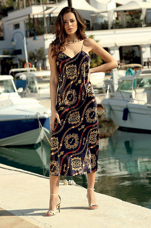 DKaren elegant satin nightdress model posing by the marina, showcasing a classy long nightshirt with adjustable straps in a striking print featuring gold and red designs, perfect for sophisticated women's loungewear.