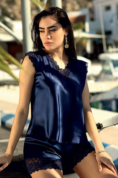Luxurious navy blue satin lingerie set from DKaren featuring elegant black Skylor lace, model showcasing the delicate blouse with lace sleeves and shorts designed with lace trim.
