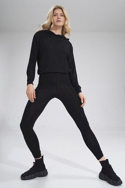 Luxury Figl long leggings featuring a creased design, styled elegantly with a black hoodie and sophisticated black sneakers for a chic look.