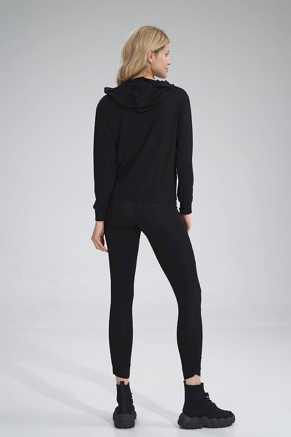 Back view of luxury Figl long leggings, styled with a black hoodie, epitomising elegance and comfort in a fashionable outfit.