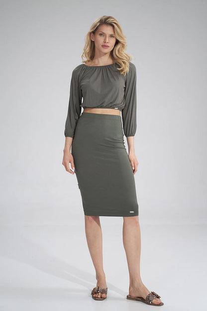 Elegant model showcasing a Figl cropped 3/4 sleeve pleated blouse paired with an olive pencil skirt, exuding sophistication.