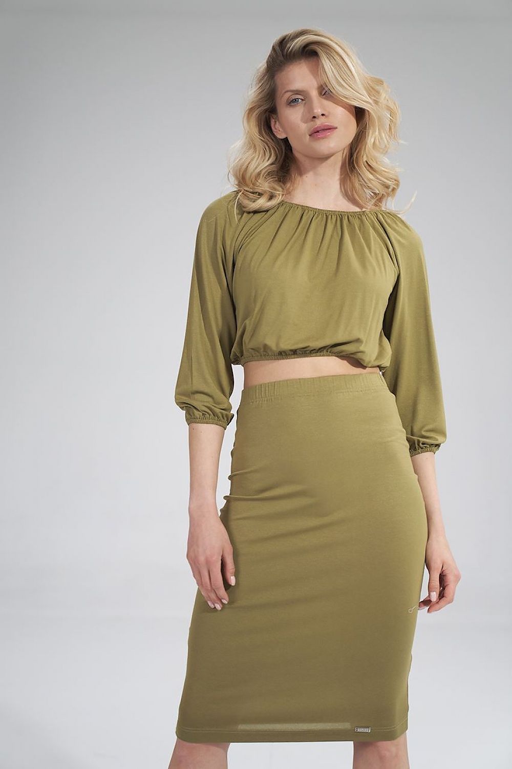 Elegant olive green pleated blouse paired with a matching skirt, showcasing a sophisticated silhouette by Figl.